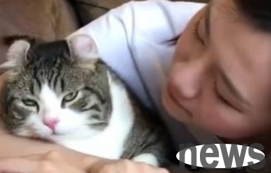 The hostess kept kissing the cat, and the cat looked disgusted
